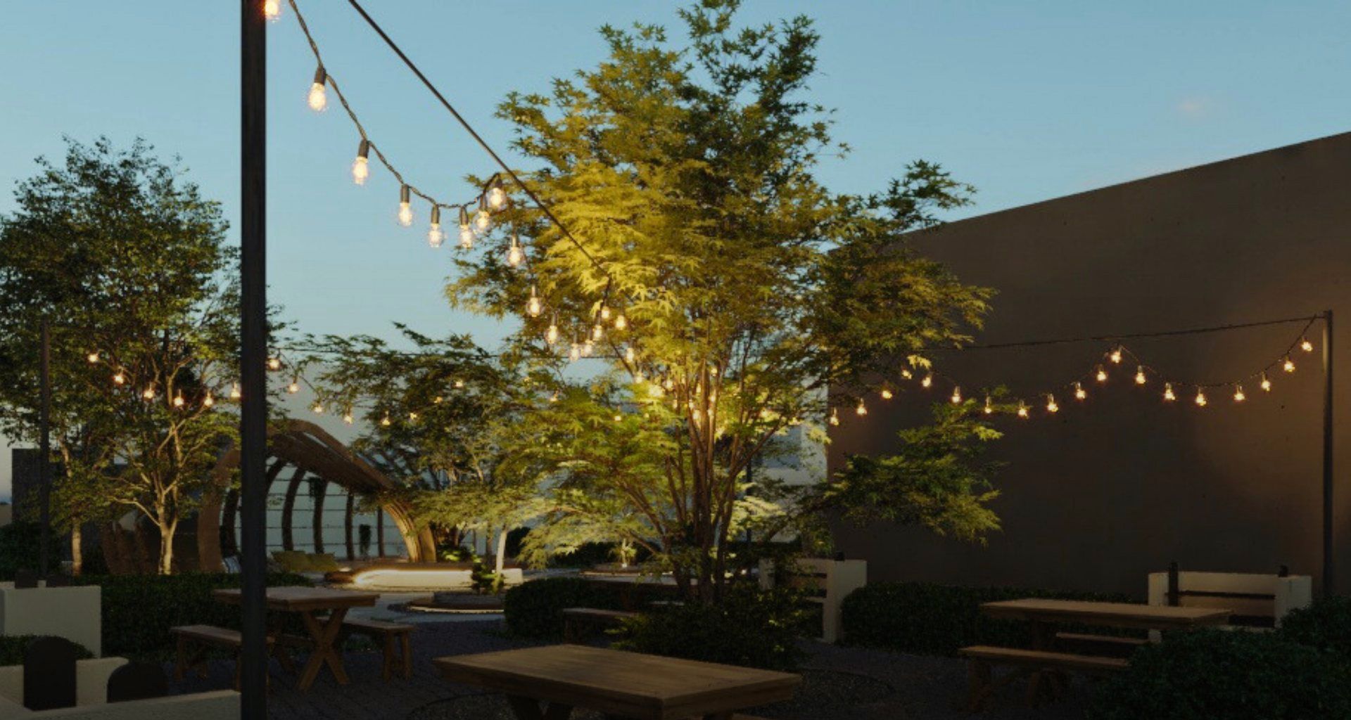 Render nocturno de mesas bajo un árbol con luces colgantes